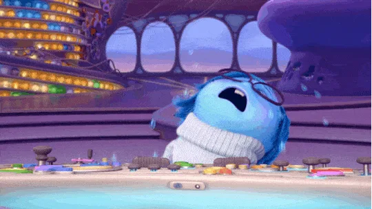 Sadness from Inside Out standing at the control console