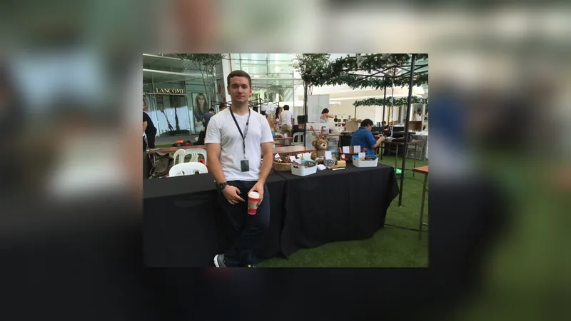 Maksim standing at a market stall inside a shopping centre