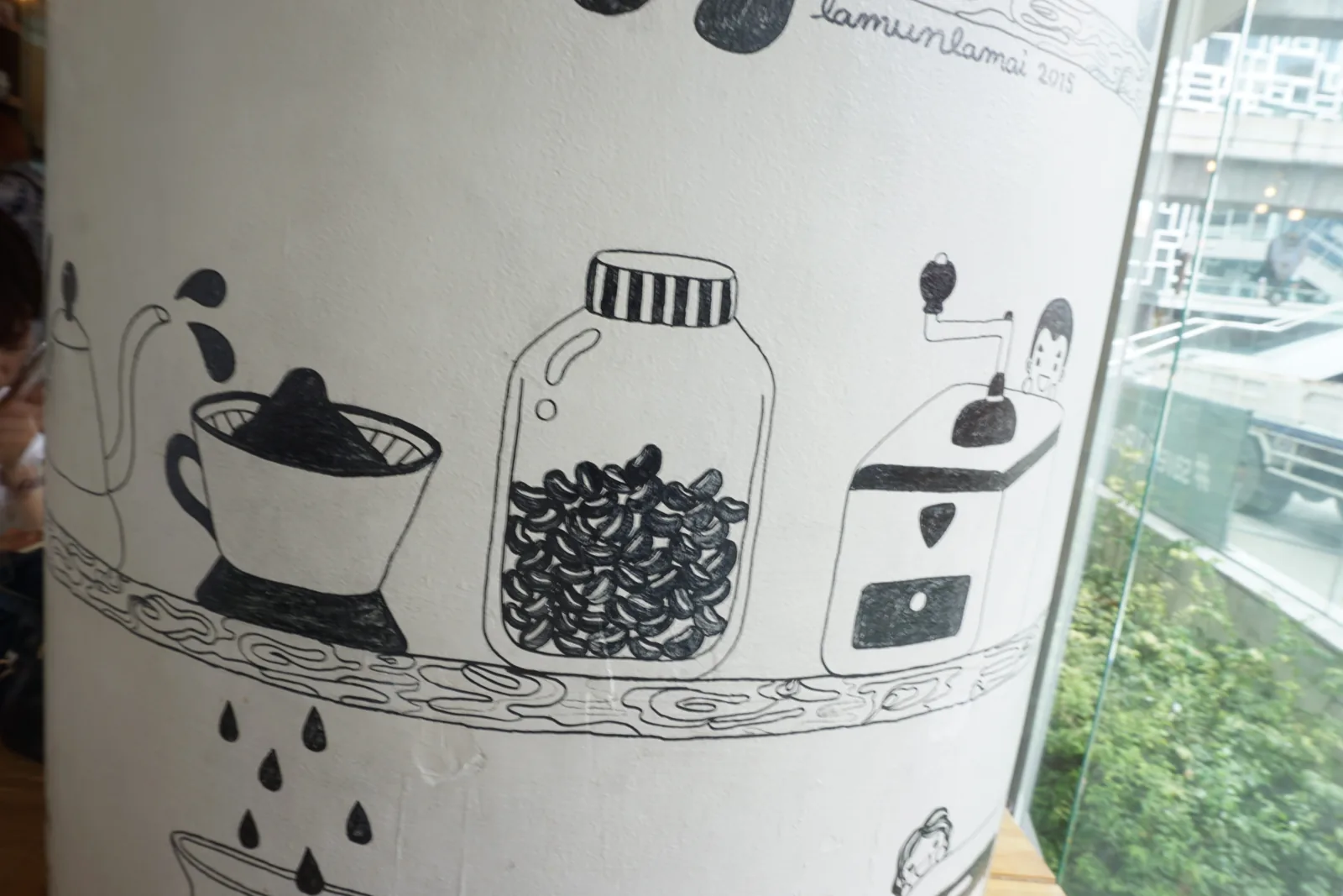 Ink drawings of jars of coffee beans and brewing equipment on a pillar
