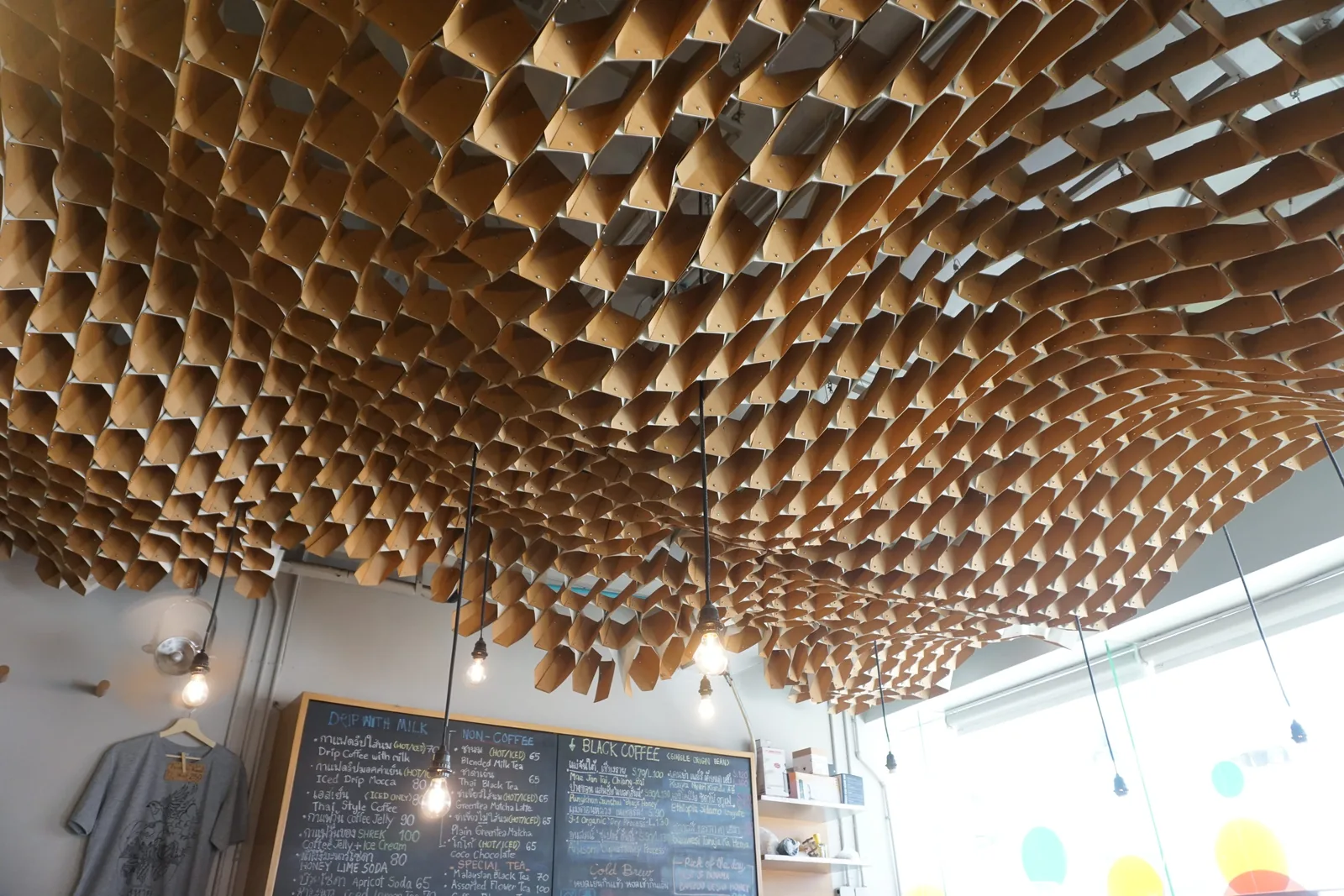A ceiling made of thousands of paper cones above the bar and the menu boards
