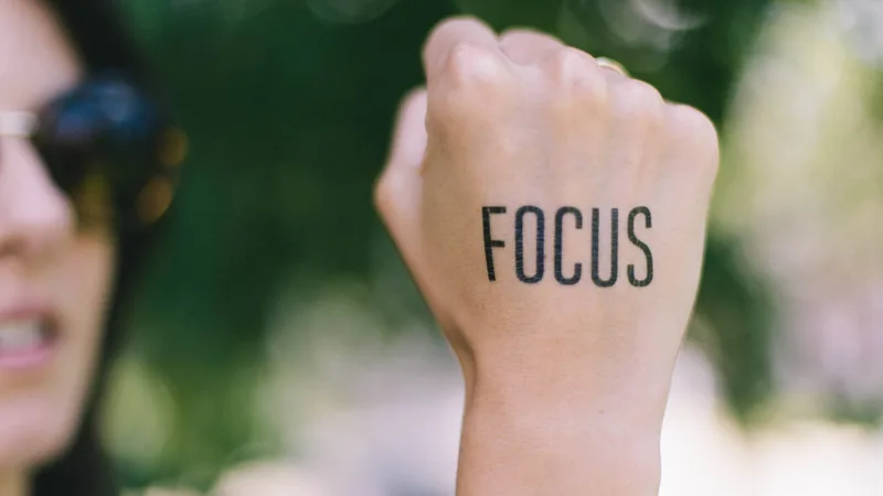 A raised fist with the word FOCUS written across the forearm
