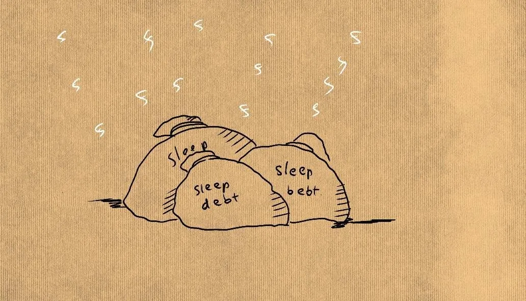 Три валуна с надписями sleep debt, лежащие друг на друге, над ними знаки сна
